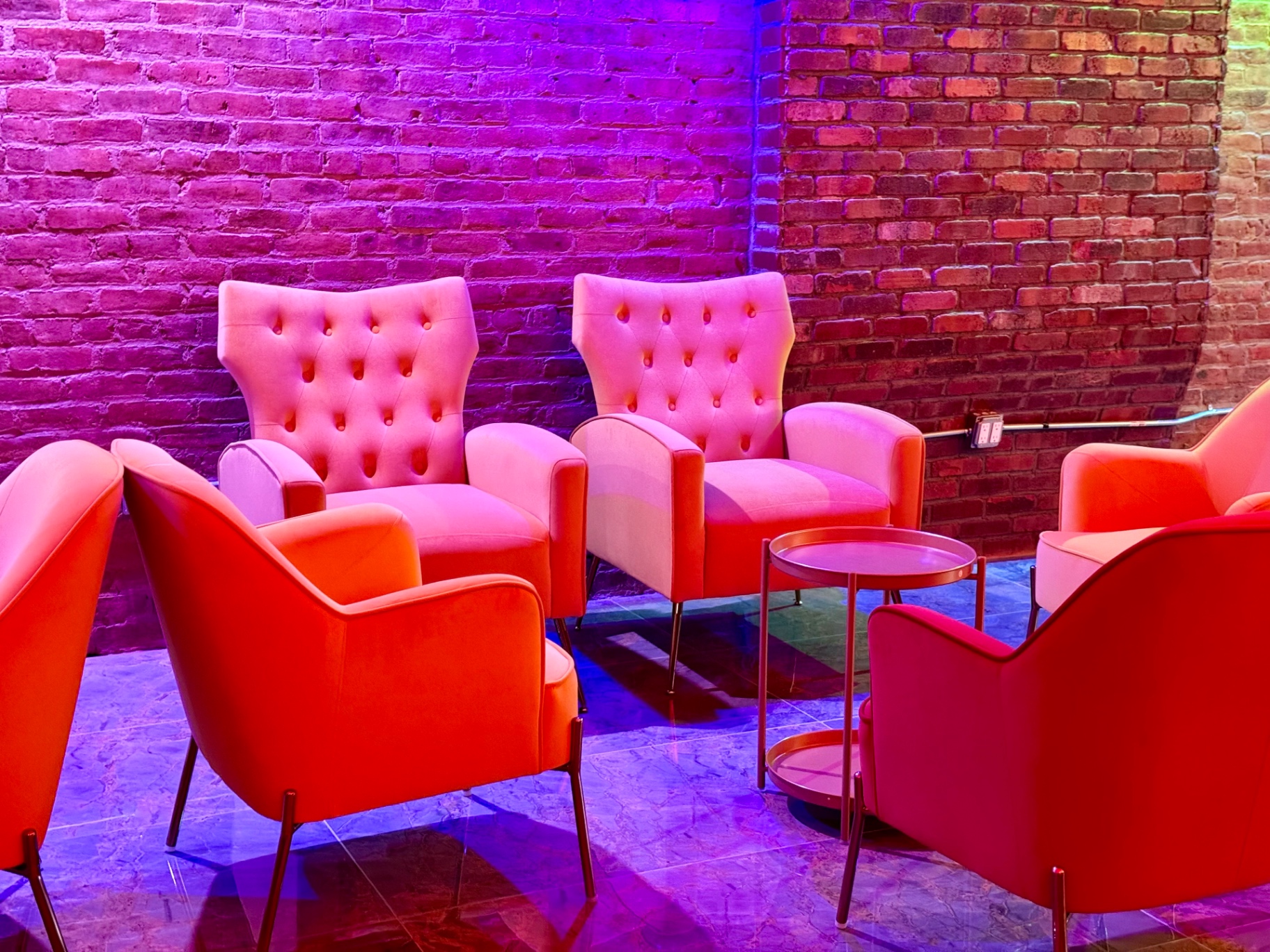 Velvet lounge on exposed brick