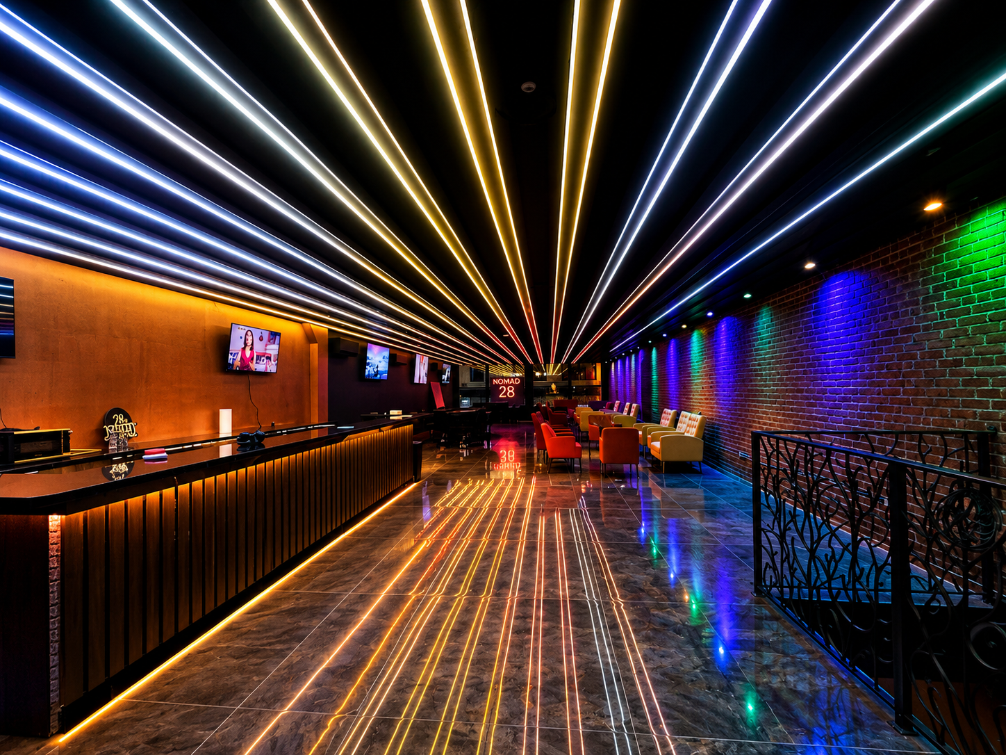 Nomad 28 neon ceiling lounge with exposed brick wall